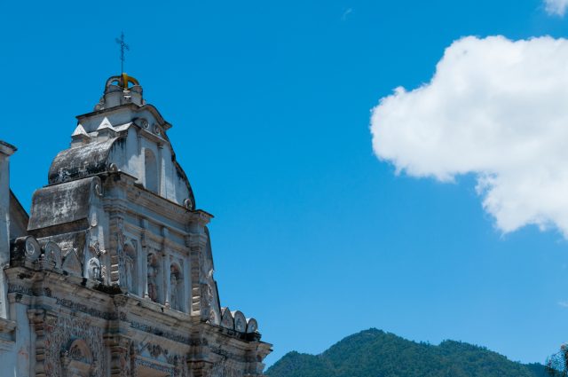 White Big Church Beside in front of mountains under blue sky with one cloud in Quetzaltenango Guatemala