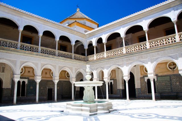 "Seville, Spain - June 13, 2012: The patio of La Casa de Pilatos, in Seville. The building is a precious palace in mudejar spanish style, the costruction was started in XV sec. by Pedro Enriquez de Qui&ntilde;ones and his wife Catalina de Rivera . At the center of the patio, a nice fountain."