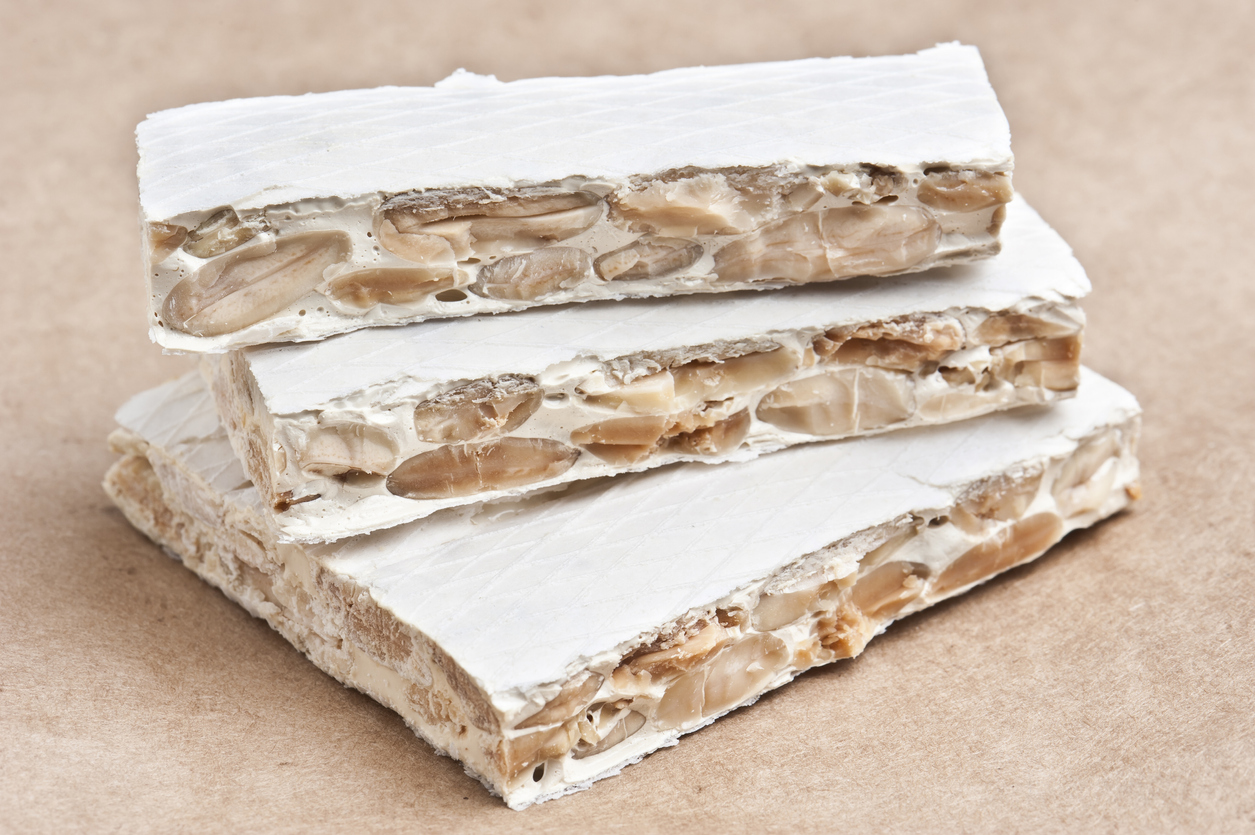 Classic Hard Spanish Turron on White BackgroundThis traditional dessert is very popular in Spain and Latinamerica in Christmas time and New Years eve celebrations