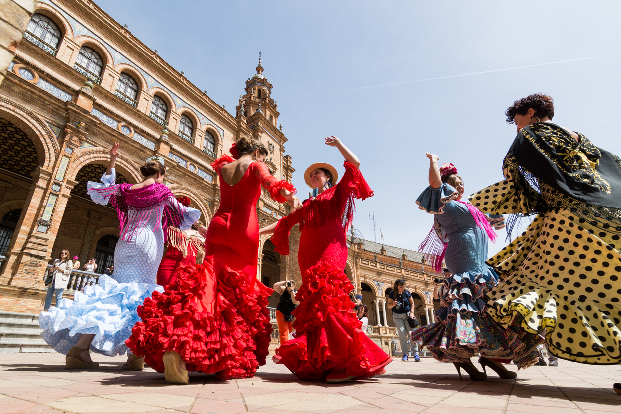 Seville, Spain - May 2017: Young women dance flamenco on Plaza de Espana during famous Feria festival