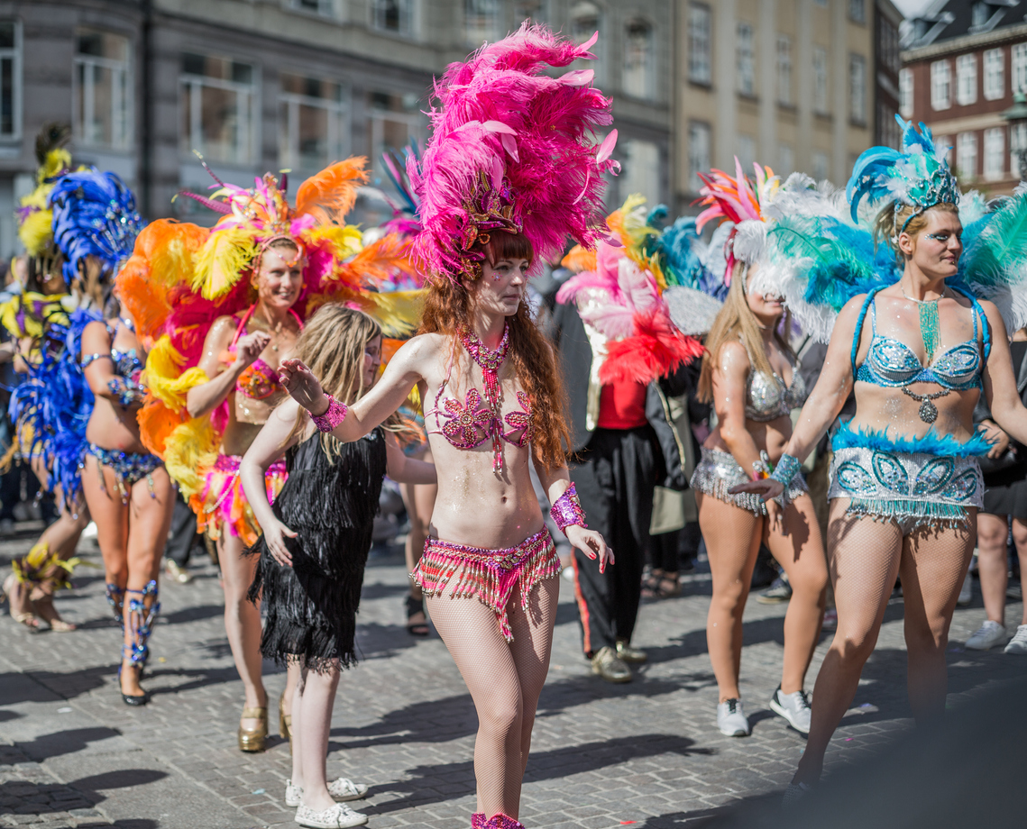 Copenhagen, Denmark - May 14, 2016: Young women in beautiful colorful costumes parading in the Copenhagen Whitsun Carnival, 2016.
