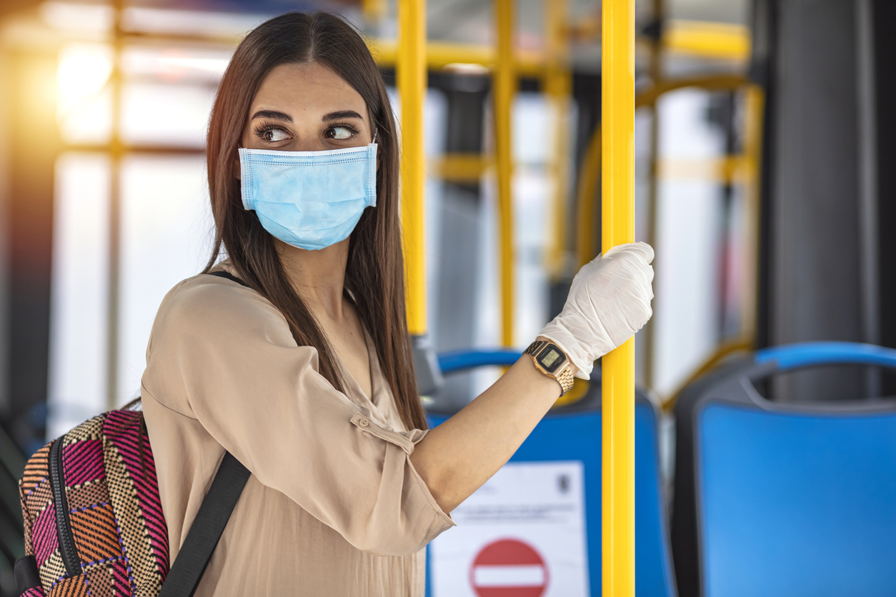 A young woman on public transport during the pandemic. A young woman in an empty public transport during the pandemic. Coronavirus. Virus protection in public transportation